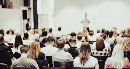 Business speaker giving a talk at business conference event.
