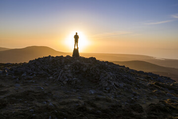 Silhouette of a person in the mountains at sunset in Snowdonia North Wales