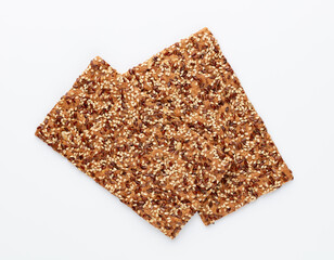 Tasty crackers with seeds on the white background.