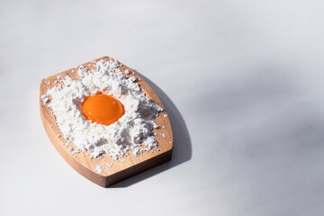 Two ingredients eggs and wheat flour on white background. Concept for bakery and making pasta