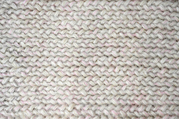 Knitwear gray-white large knitting lies on the table. View from above. Flat lay, top view,...