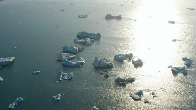 Aerial panoramic shot of ice floes on arctic lake surface. Amazing Nordic landscape scenery. Iceland