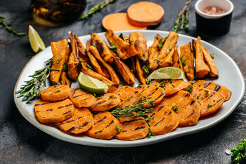 Homemade Baked orange sweet potato fries with lime and herbs, Food recipe background. Close up, top view