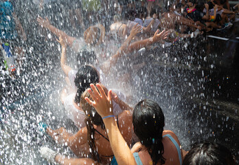 Boys and girls participate in a party with water in the streets. Water party.