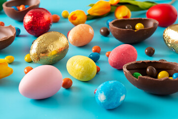 Fototapeta na wymiar Colorful chocolate Easter eggs on blue bckground