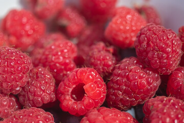 Closeup red raspberries.. Blurred foreground. Blur and selective focus. 