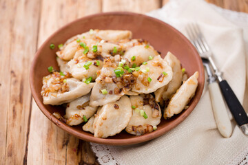 Ukrainian dumplings with fried bacon and onions