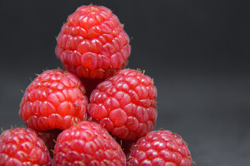 Fresh and organic raspberries against a black background