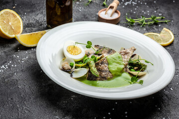 Naklejka na ściany i meble Fish dish - fried fish fillet of zander served with mussels, peas, asparagus and vegetable cream sauce. Restaurant menu, dieting, cookbook recipe