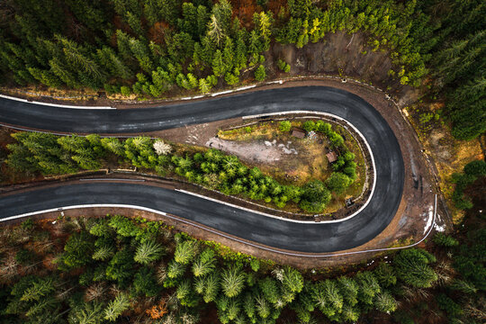 Picturesque mountains and serpentine roads, forest and road in the fog, steep turns of roads, road in the mountains.