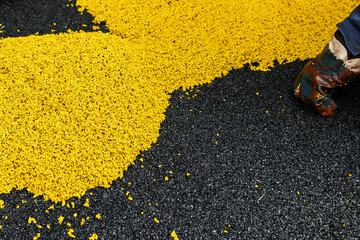 yellow rubber crumb lies on a black background. Application of decorative soft safety coatings.
