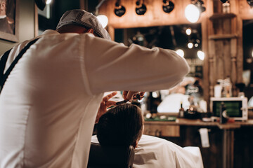 man sitting in a barbershop chair