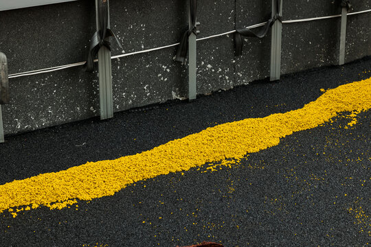 Adjust Rubber beads floor. Shredded and cut pieces of used recycled rubber tire crumb reused soft surface ground floor filler mulch compound on children amusement for safety and injury prevention - Powered by Adobe