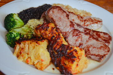 Close up of a plate of beef steak slices with sauerkraut, lentils and brussel sprouts for high protein ketogenic meal 