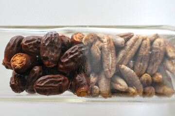 Close up of date fruit seeds inside a glass bottle