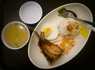 Typical Filipino breakfast of sinangag (fried rice), egg and marinated bangus fish