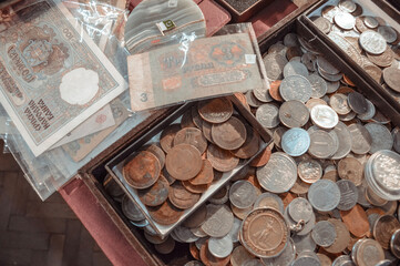 Old coins and paper money are on the table. Top view
