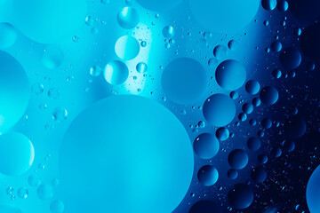 oil with bubbles on dark blue background. Abstract space background. Soft selective focus. macro of oil drops on water surface. copy space. air bubbles in water