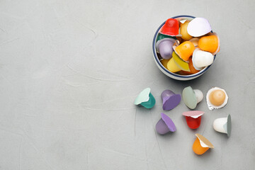 Bowl with tasty bright jelly cups on light table, flat lay. Space for text