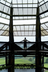 Full length view of unrecognizable man sightseeing on viewpoint in Colombian valley. Vertical panoramic rear view of man outline traveling in Filandia. People and travel destination in South America.