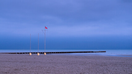 Jetty in the sea on a cloudy evening in autumn