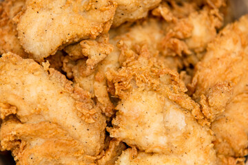 Breaded chicken fillet in bucket. fried chicken strips with take a way bucket