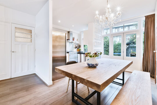 Charming dining room with a solid table and a crystal chandelier
