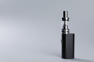 Electronic cigarette on light background, space for text