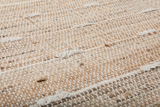 Stylish beige rug as background, closeup. Interior accessory