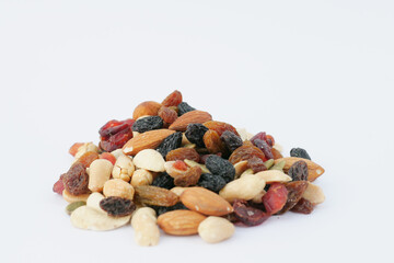 close up of many mixed nuts on white background 