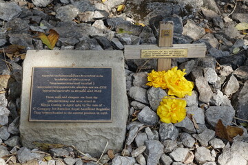 Stone, cross, metal plate and flowers commemorating the Australian victims of the construction of Thai Burma Railway (Death Railway), Hellfire Pass, Chong Kao Khat, Kanchanaburi, Thailand