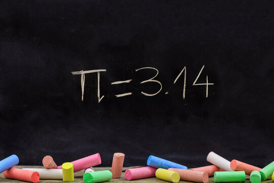 Pi number, mathematical constant chalk drawing on a school black board