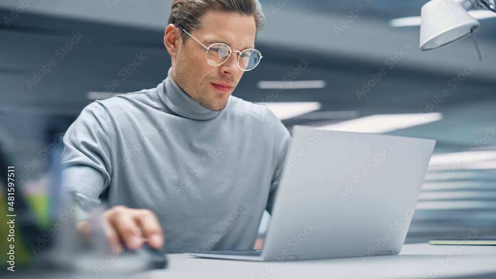 Poster modern office: productive businessman sitting at his desk working on a laptop computer. man working 