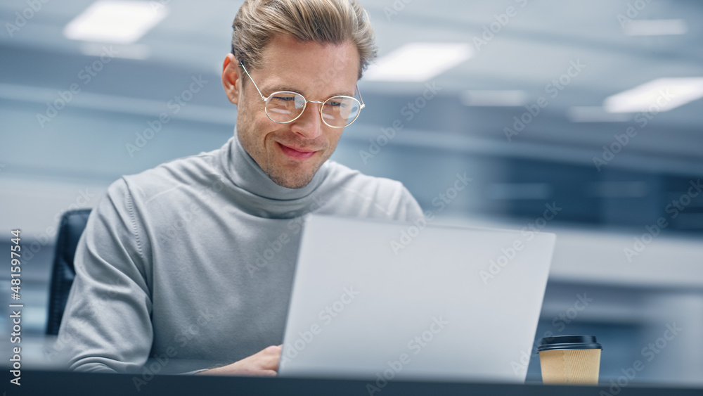 Poster Modern Office: Smiling Productive Businessman Sitting at His Desk Working on a Laptop Computer. Man working with Big Data e-Commerce Analysis. Energetic Shot with Motion Blur Background