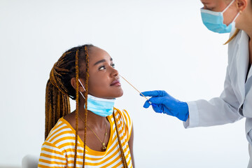 Black woman patient looking at doctor making PCR test