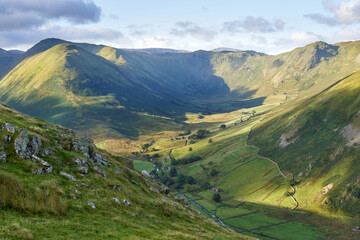 The Nab, Rest Dodd, Brock Crags and Heck Crag in warm sunlight above Bannerdale Beck in Martindale in the English Lake District, England, UK.