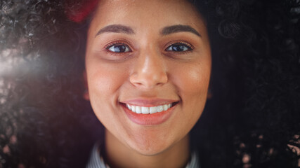Close-up Portrait of a Gorgeous Young African American Woman with Brown Eyes Smiling Charmingly....