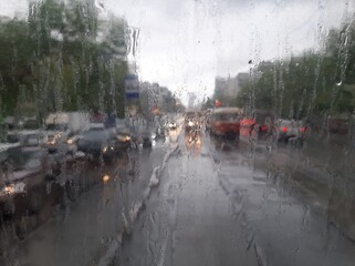 View of the road through a wet window