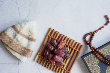 Holy book Quran and rosary on table, close up.