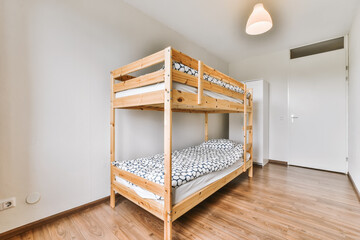 Lovely bedroom with wooden bunk bed and chandelier