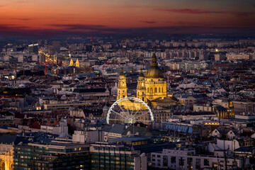 Elevated view of the illuminated urban skyline of Budapest, Hungary, with the famous St. Stephen's Basilica during dusk