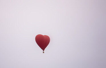 Fototapeta na wymiar a balloon with a basket is flying high in the sky