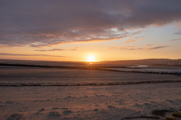 Sunset along Llanelli beach in Wales.