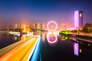 Fototapeta na wymiar Night scene cityscape of Tianjin ferris wheel,Tianjin eyes in twilight time.Most Modern and popular landmark in Tianjin city.