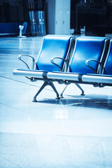 In a station, there are blue seats inside.