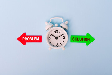 Problem vs Solution. Red arrow and green arrow- direction indicator - choice of Problem or Solution. Concept of choice. Two Arrows and clock on blue background, top view