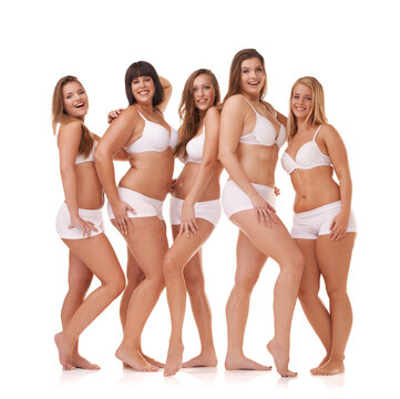 Her confidence is all natural. A group of women with different body shapes standing together in their underwear while isolated on white.