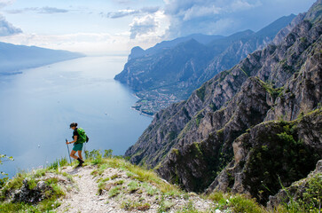 garda lake hiker with hiking sticks beautiful view

