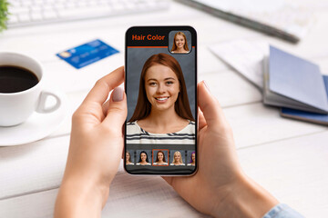 Woman using hair color simulation software on mobile phone