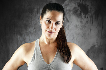 Portrait of athletic muscular woman in studio